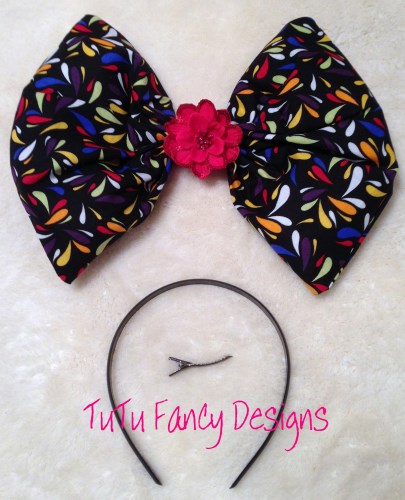 Over-sized Black Hair Bow with multicolored drops on it.